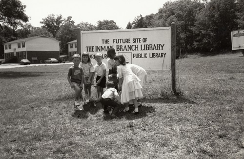 Inman Library - Regular attendees of the Inman Library’s story hour break ground on the new building on July 15, 1990. Shown from left to right are Shawn Skelton, Sonya Skelton, Richard Holt, Bart Copeland, Erin Griffin, Kirsten Jolley, Merri Grace Spencer, and Caleb Spencer.