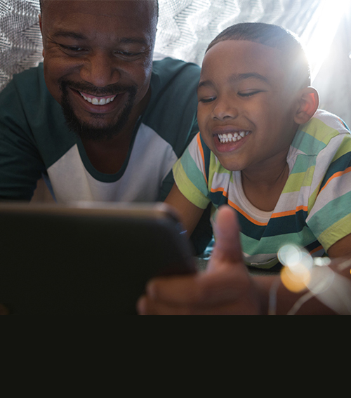 Man and child looking at tablet